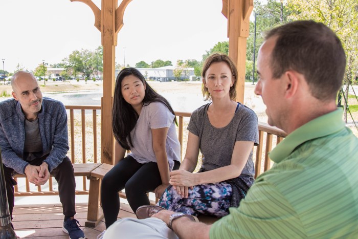People in a discussion in a gazebo outside at Wilmington Treatment Center
